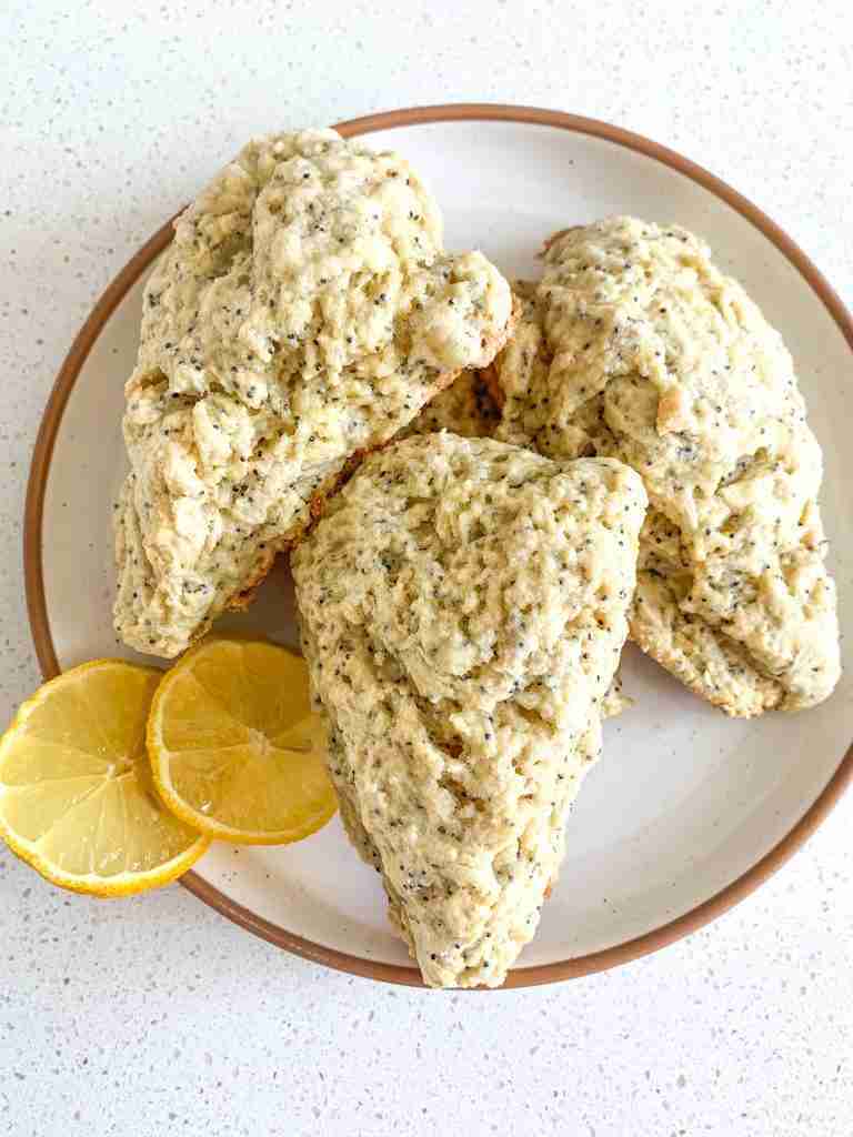 4 scones on a plate with 2 lemon slices