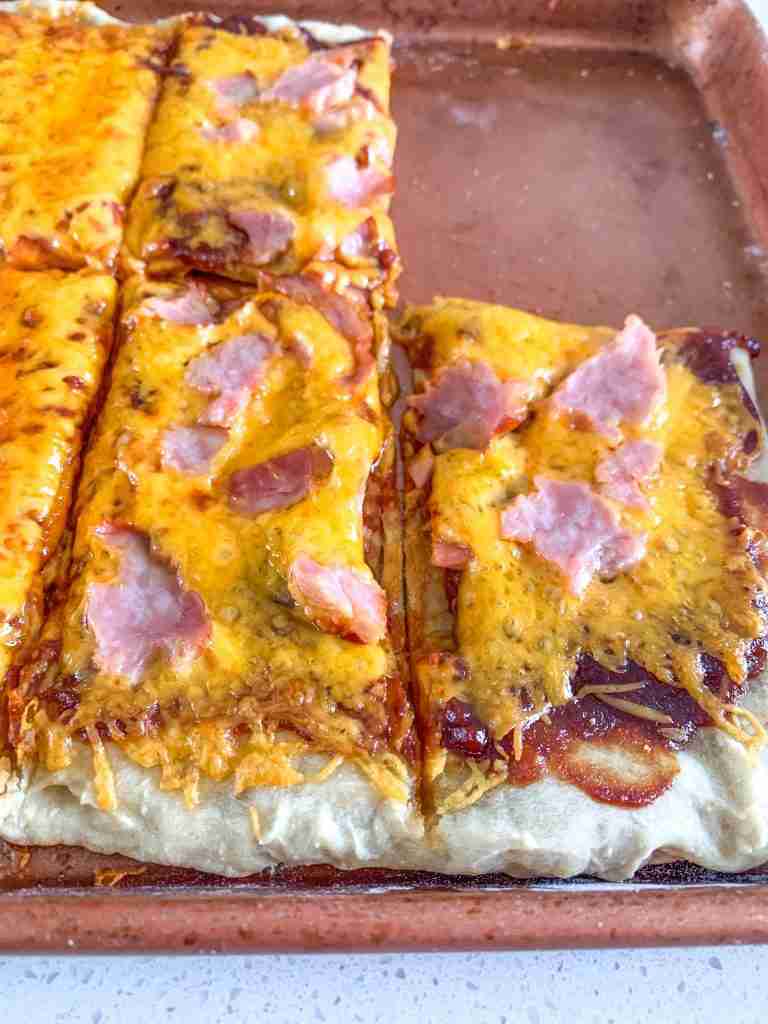pizza topped with cheese and ham