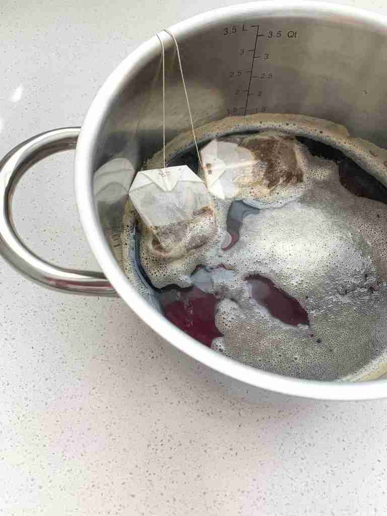 pot of tea with bags seeping in it on the counter