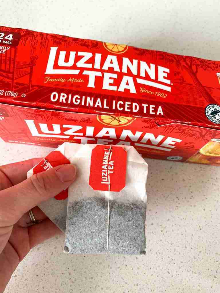 Luzianne tea bags in a hand