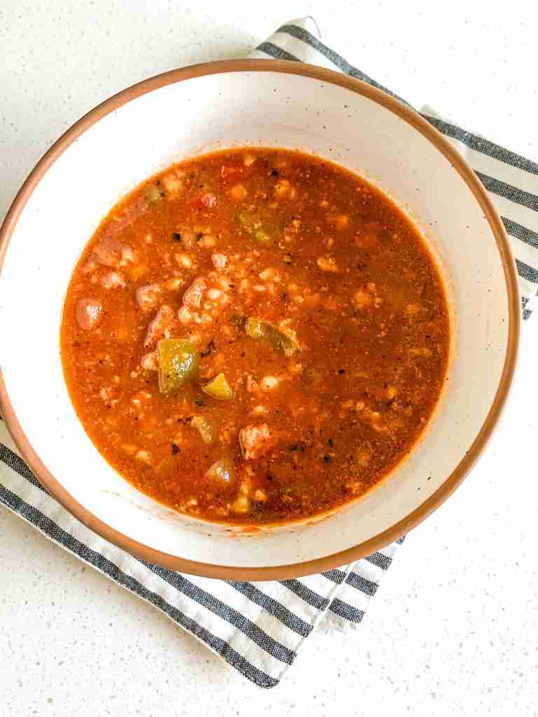 bowl of soup with a stripped cloth underneath