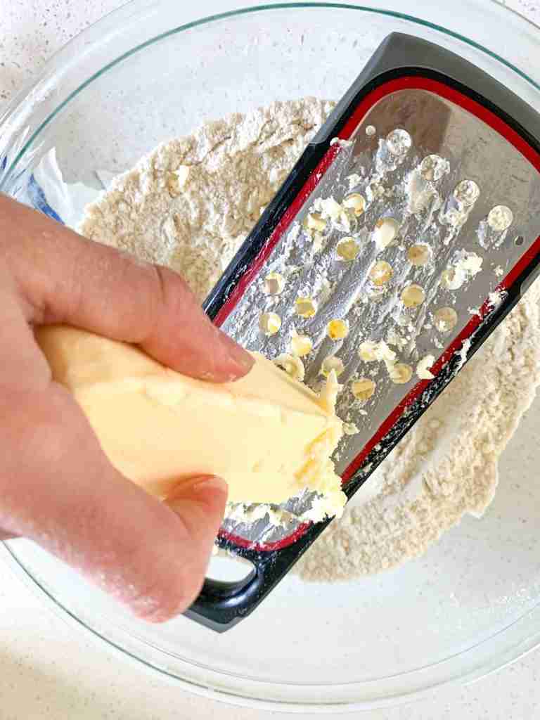 butter being grated in a bowl