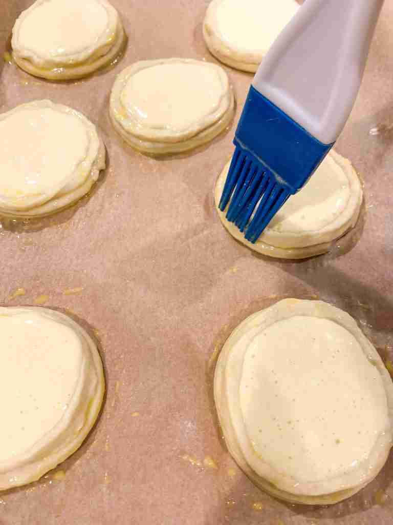 brushing egg wash onto dough