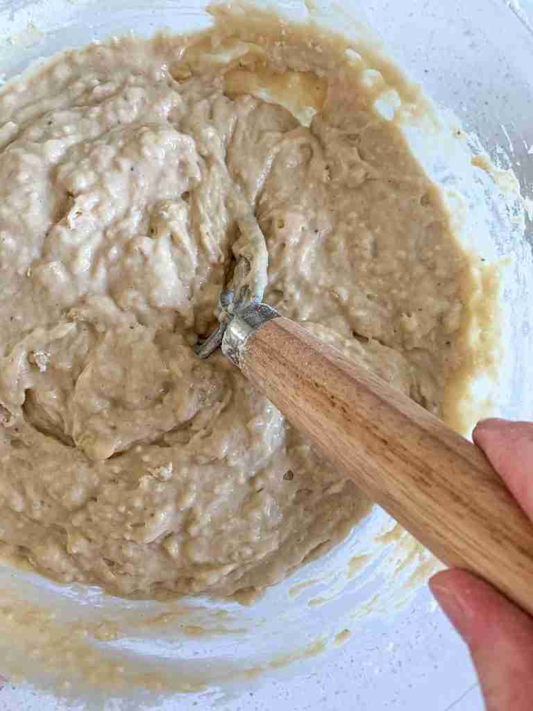 bowl of batter being whisked by hand