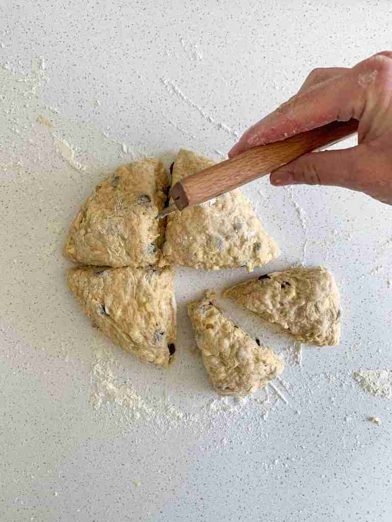 hand cutting scone dough into scones