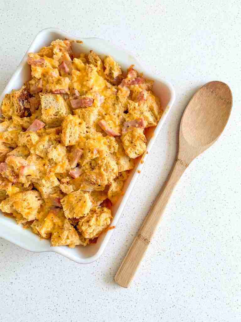 casserole dish full of food and a spoon beside it on the counter