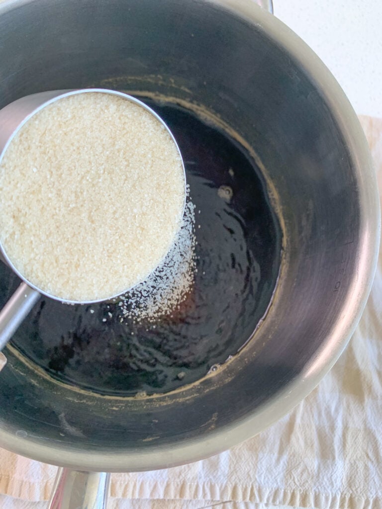 adding cane sugar to tea