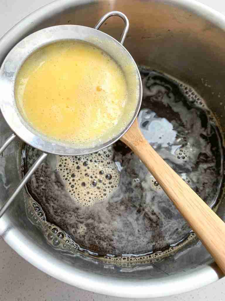 pineapple juice being strained into tea