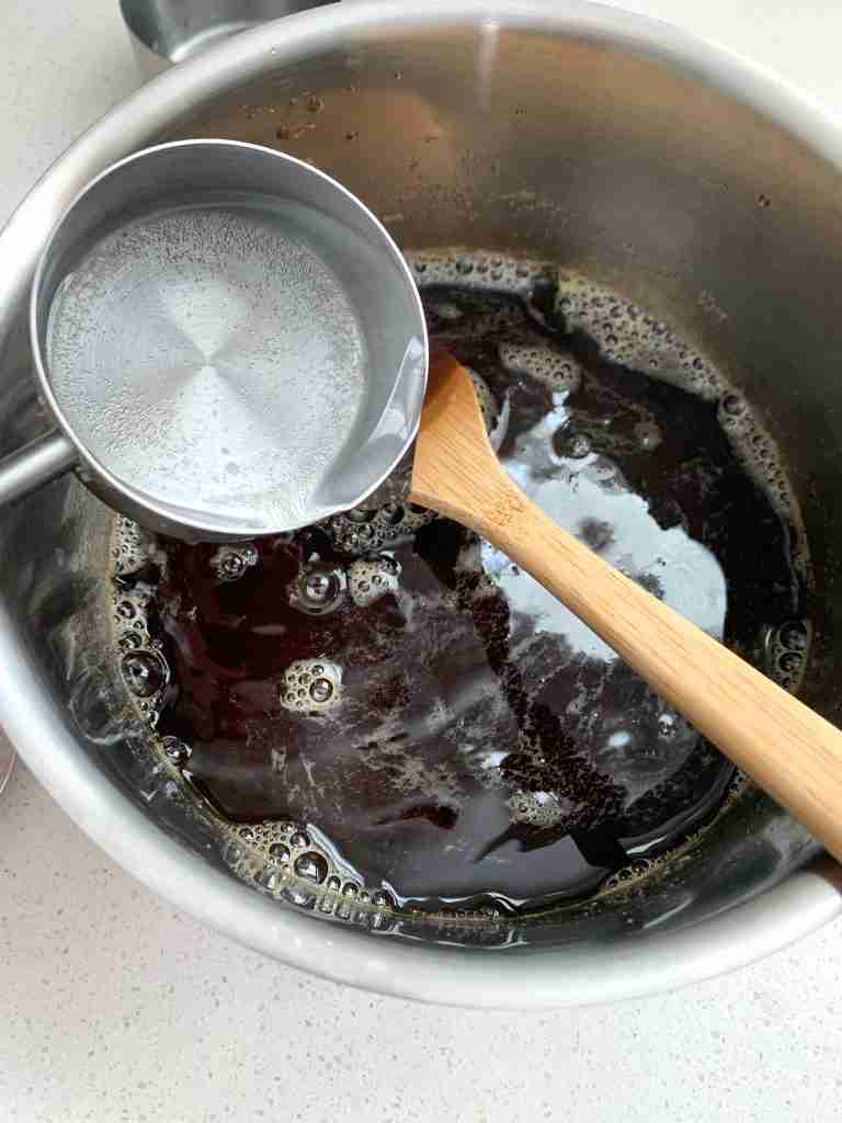 water being added to a pot of tea concentrate