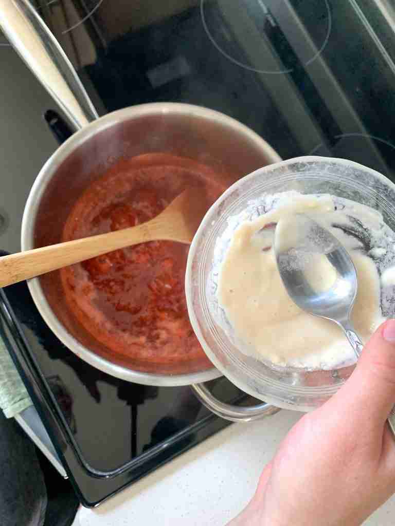 adding a slurry to thicken the mixture in the pan