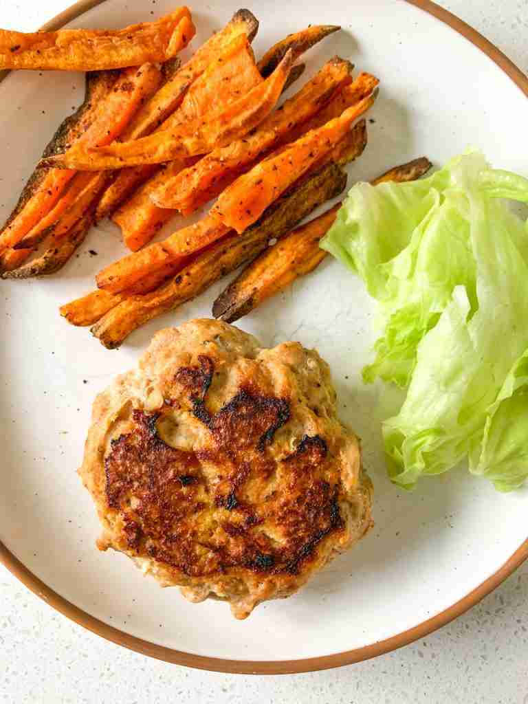burger lettuce and sweet potato fries on a plate
