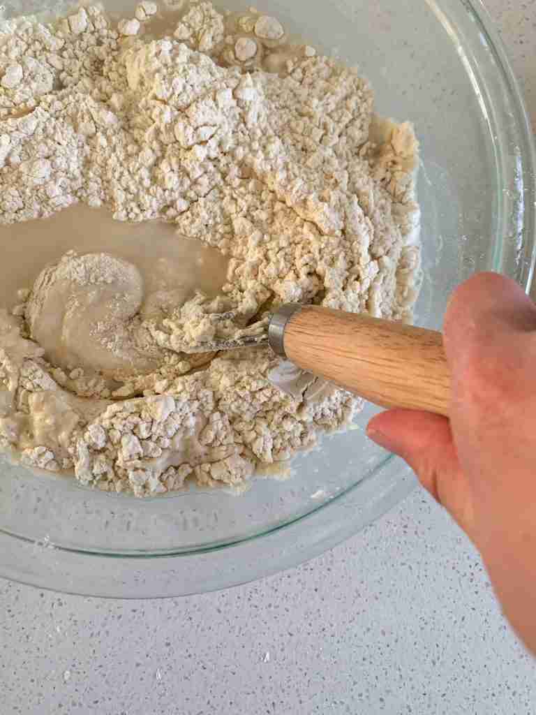 hand mixing a bowl of ingredients
