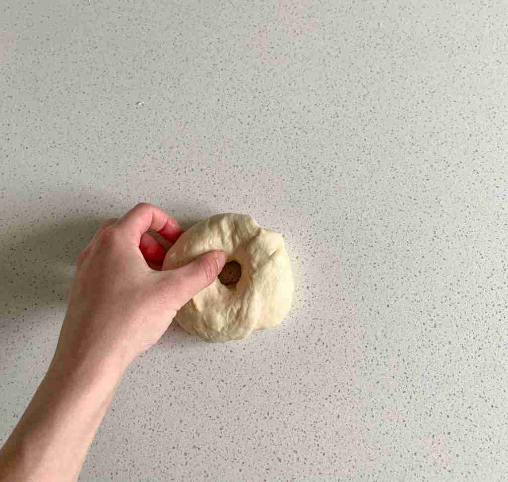 hand shaping bagel