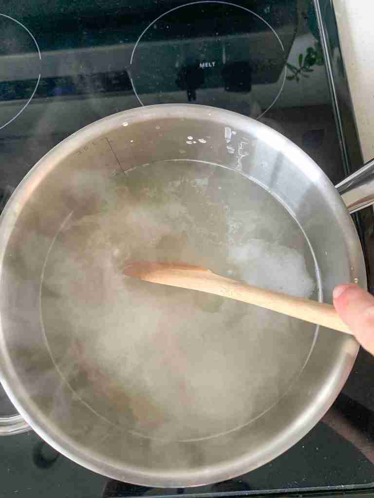 hand stirring boiling water
