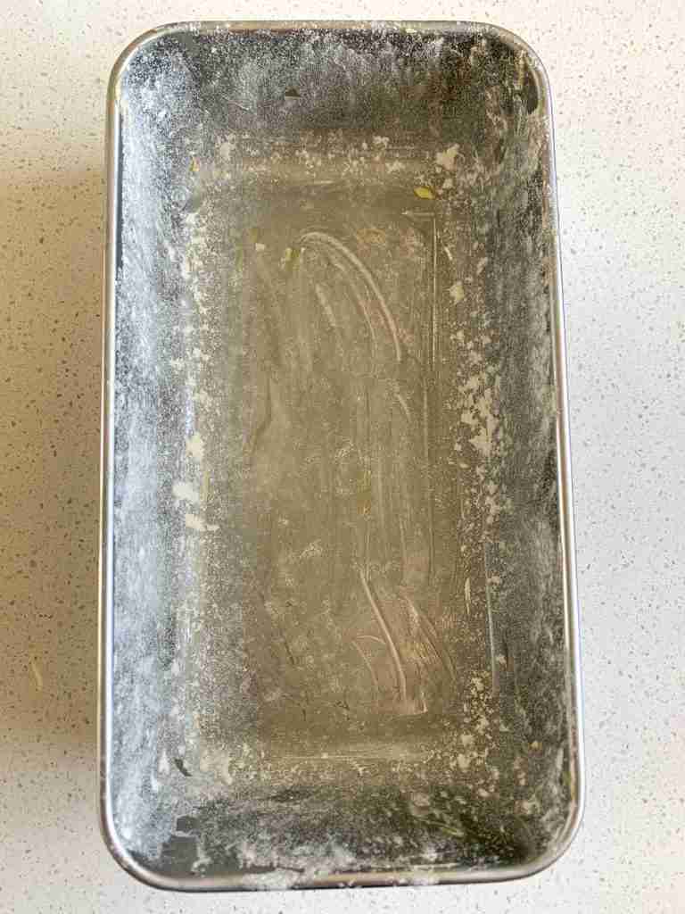 prepared loaf pan with butter and flour