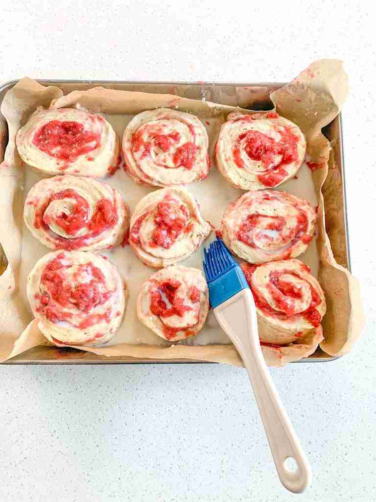 brushing sweet roll dough with milk