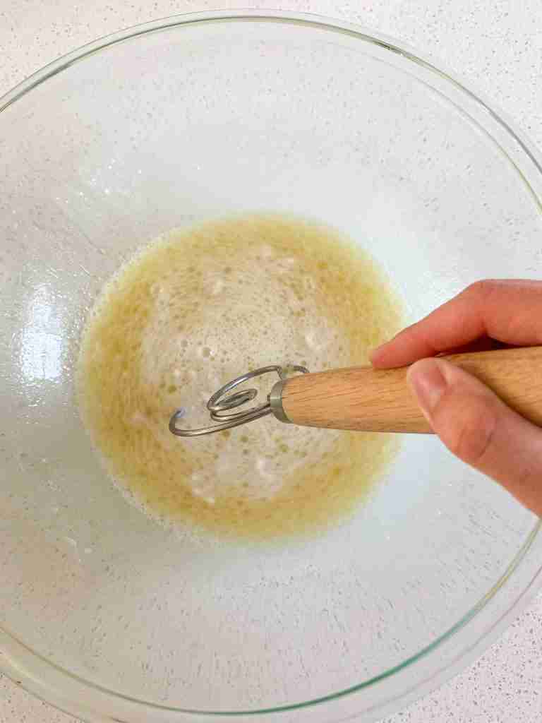 hand mixing wet ingredients in a bowl
