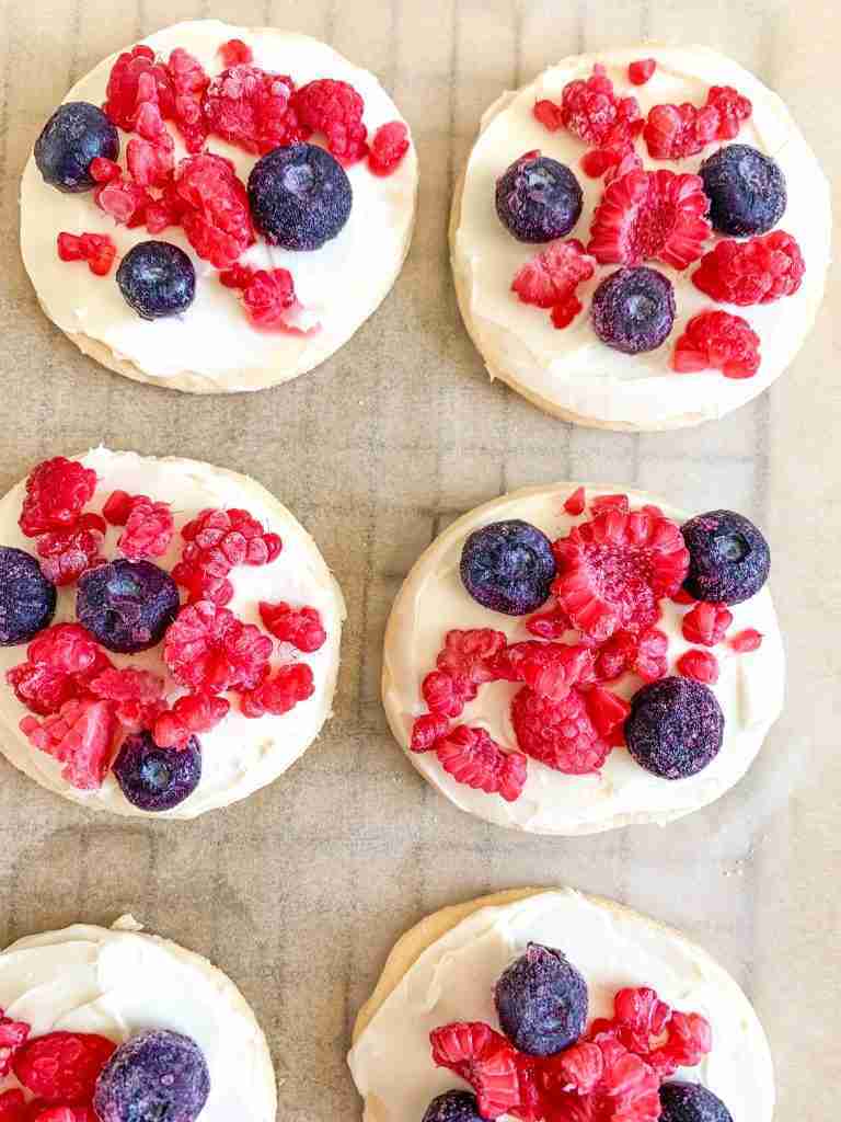 cookies frosted with fruit on top of them