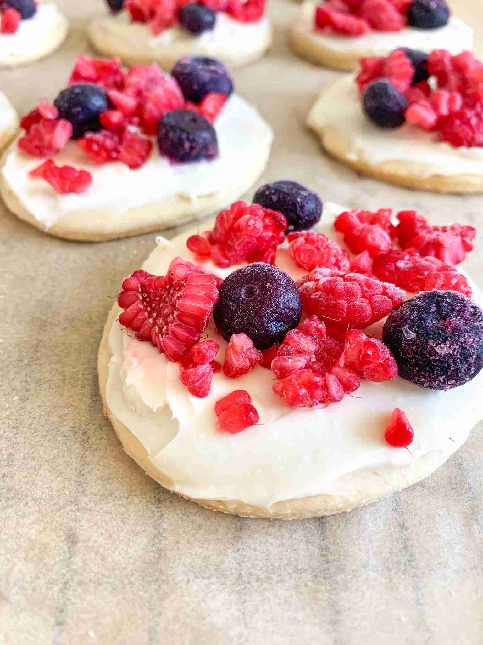 up close photo of sugar cookie with fruit and frosting