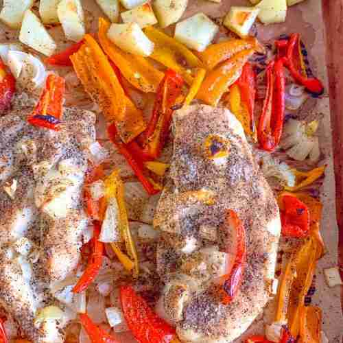 sheet pan with chicken potatoes onions and peppers