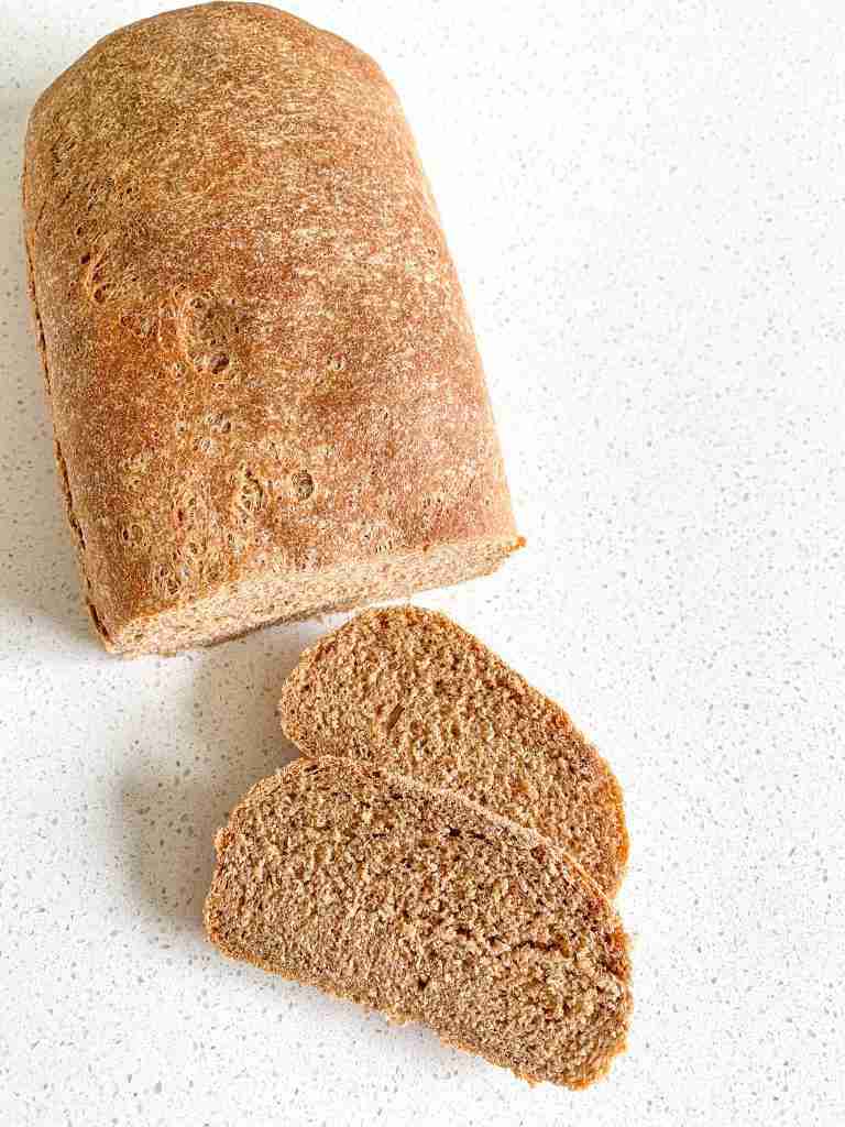 over head shot of a wheat loaf with 2 slices off