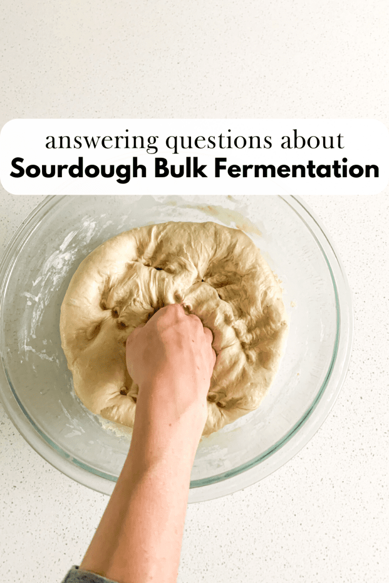 hand punching down dough in a bowl