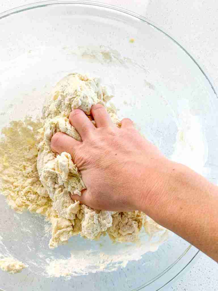 bringing croissant dough together with hand