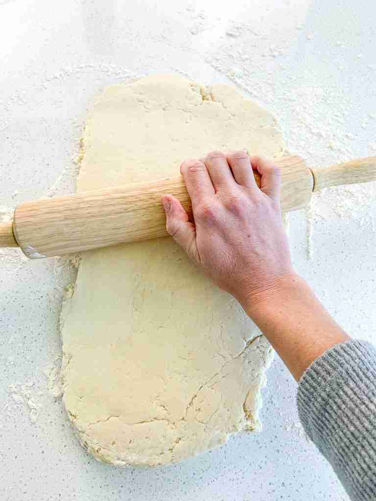 rolling out croissant dough