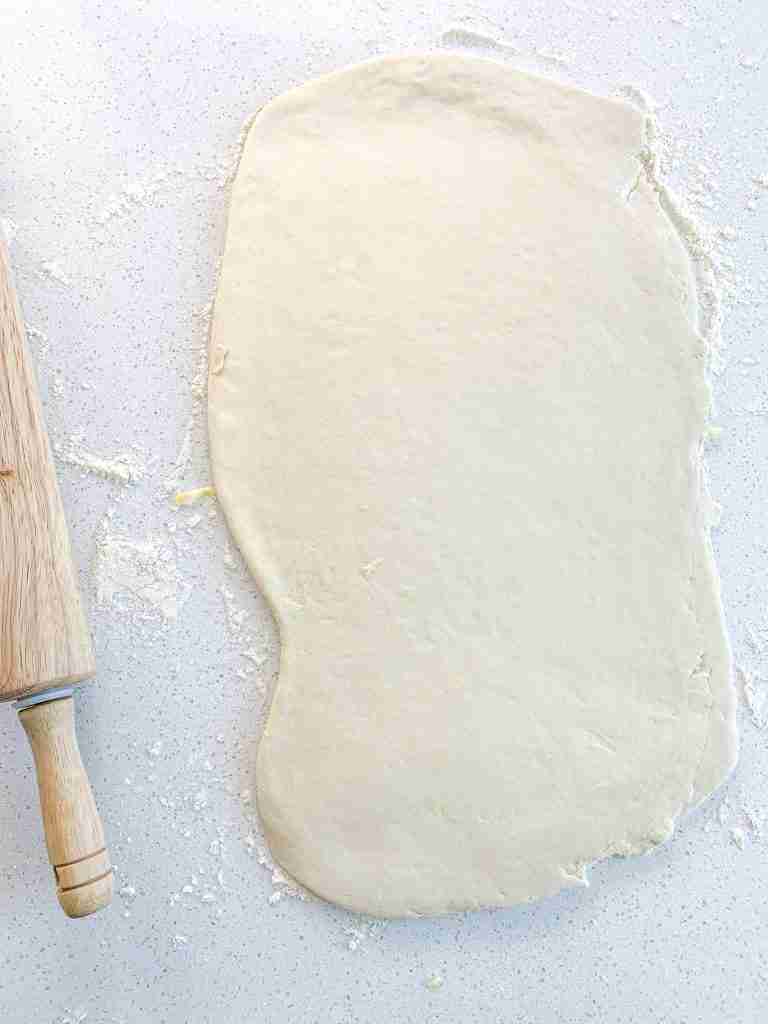 rolling out croissant dough after laminating