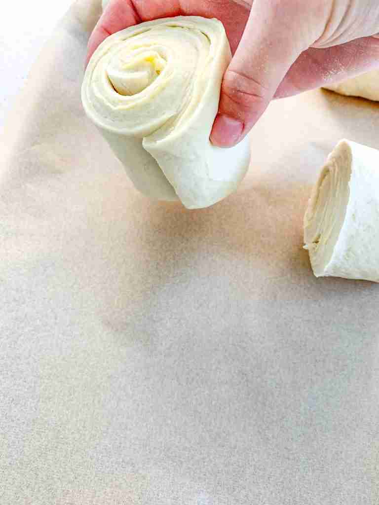 placing croissants tail down on a sheet pan