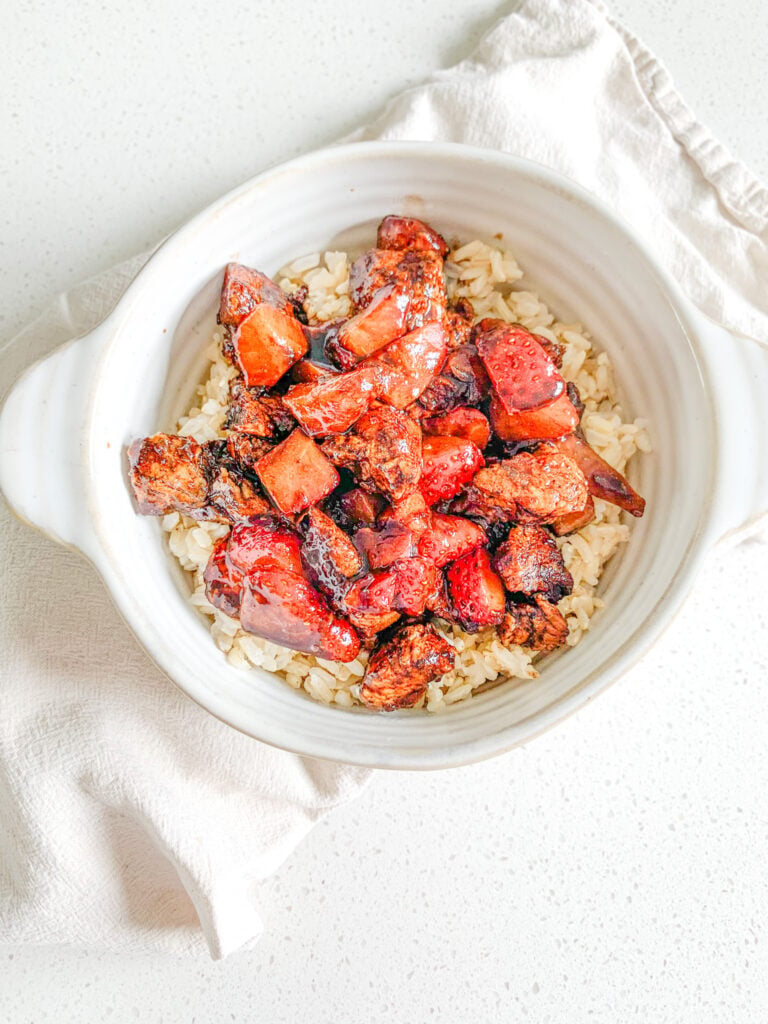 freshly made pan-seared balsamic strawberry chicken bites on a bed of brown rice