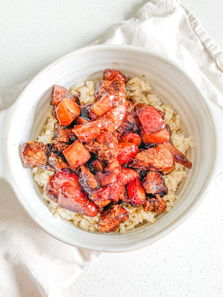 freshly made pan-seared balsamic strawberry chicken bites on a bed of brown rice