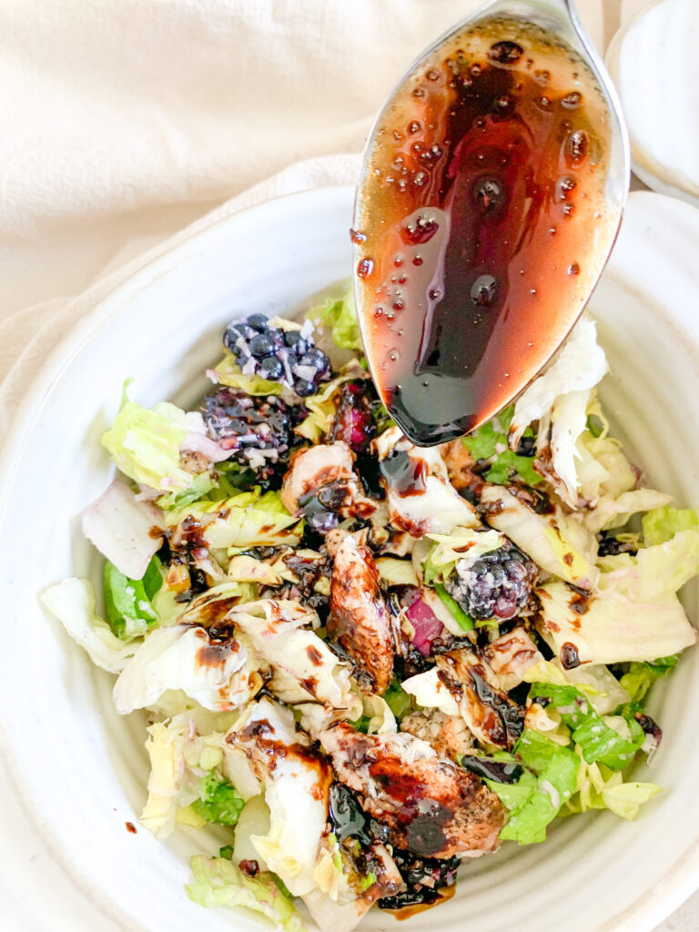 adding balsamic dressing to blackberry chicken salad