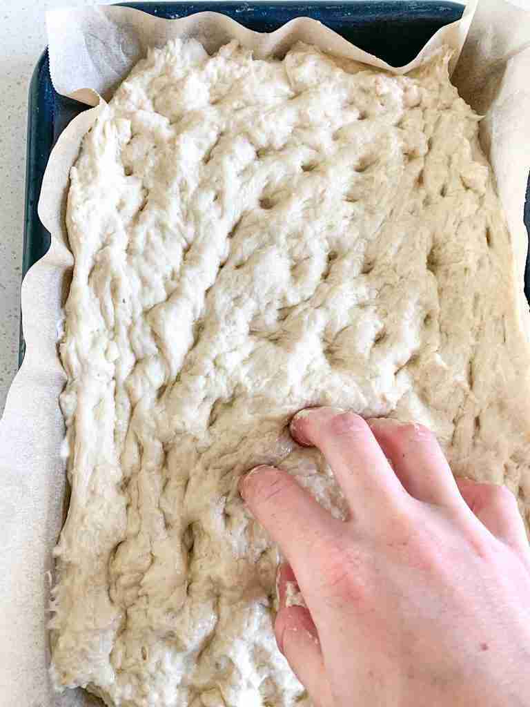 putting dimples in focaccia dough