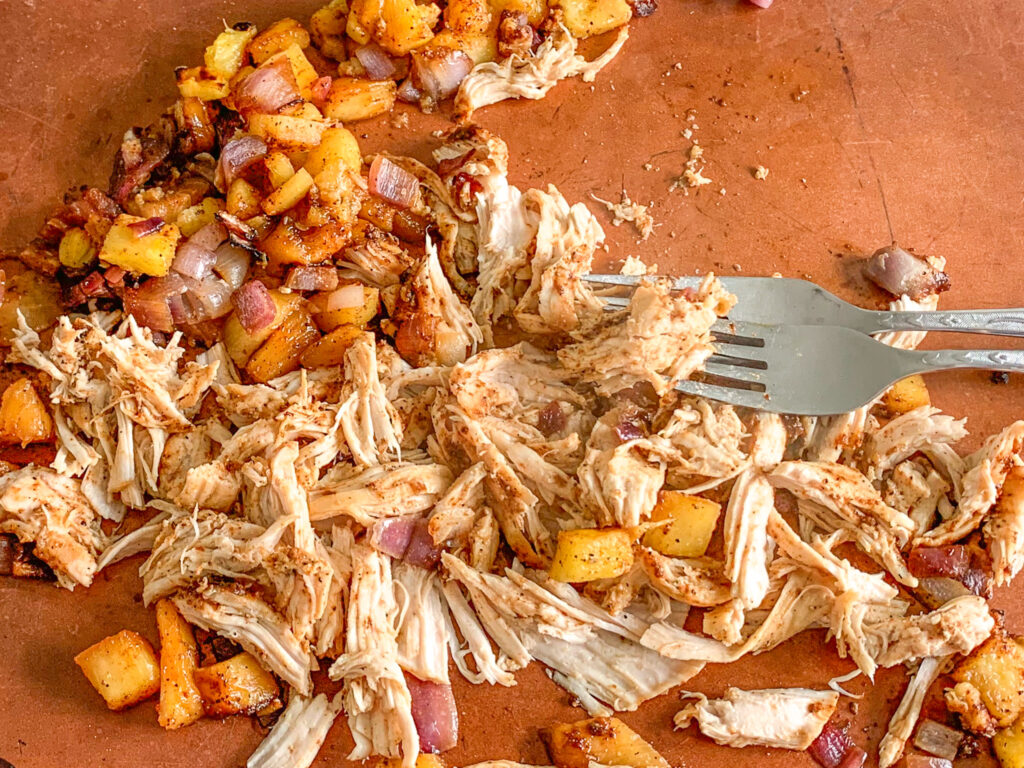 shredding chipotle chicken pineapple taco meat