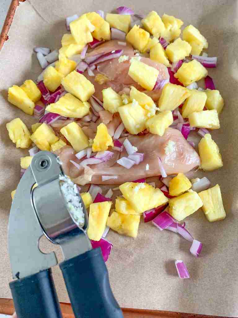 garlic being minced over chicken