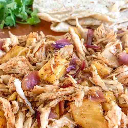 shredded taco chicken and tortillas on a sheet pan
