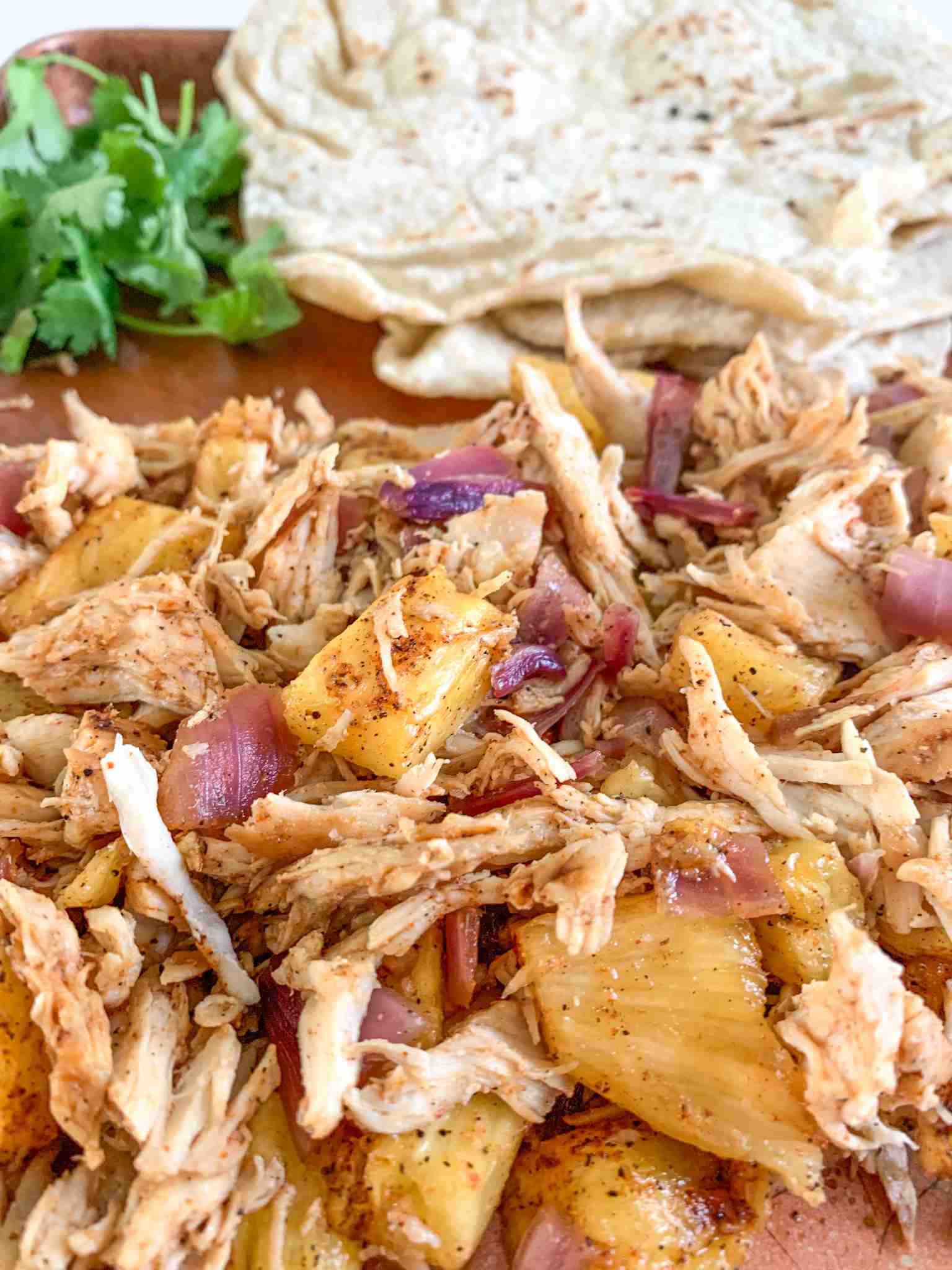 shredded taco chicken and tortillas on a sheet pan