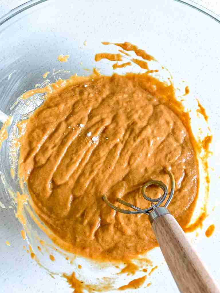 whisk mixing ingredients for pumpkin bread