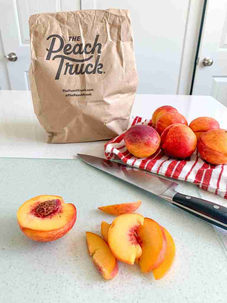 the peach truck peaches bag and slices of fruit