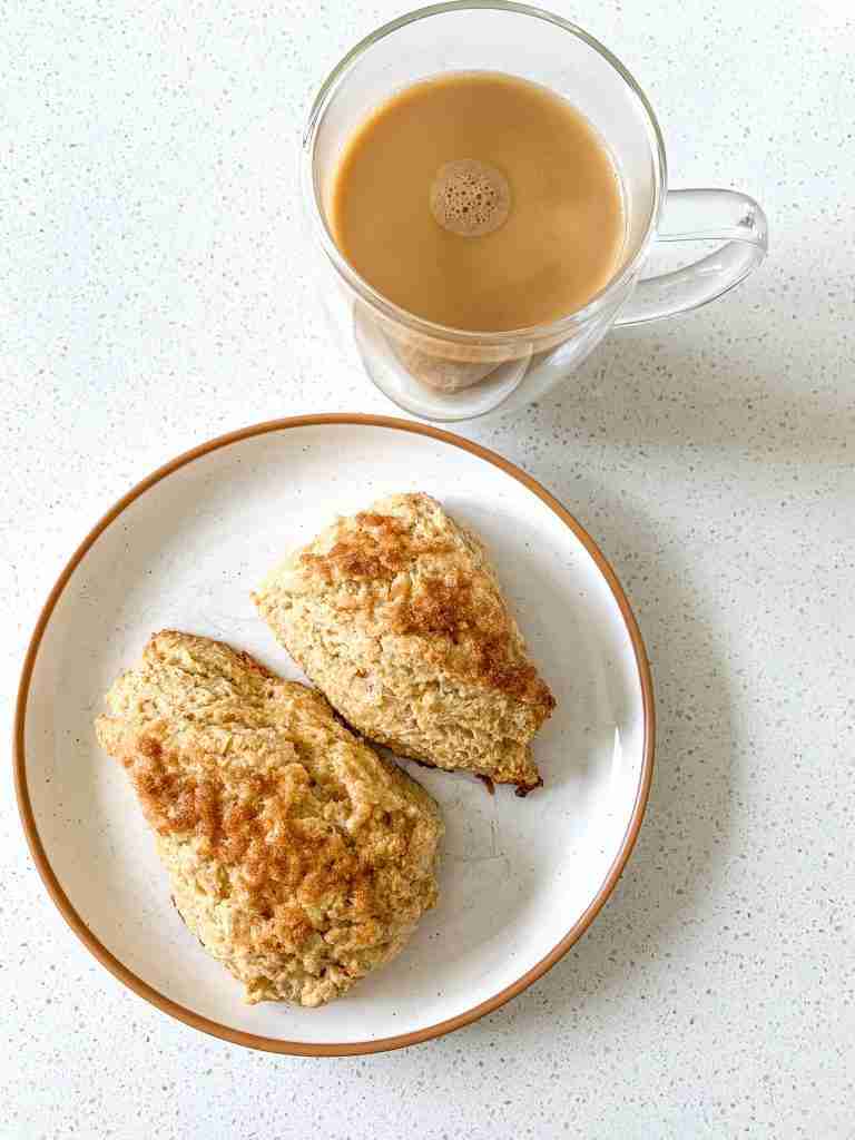 plate of cinnamon brown sugar scones and a cup of coffee