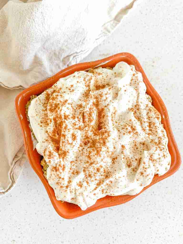bowl of pumpkin pie chia pudding with whipped cream