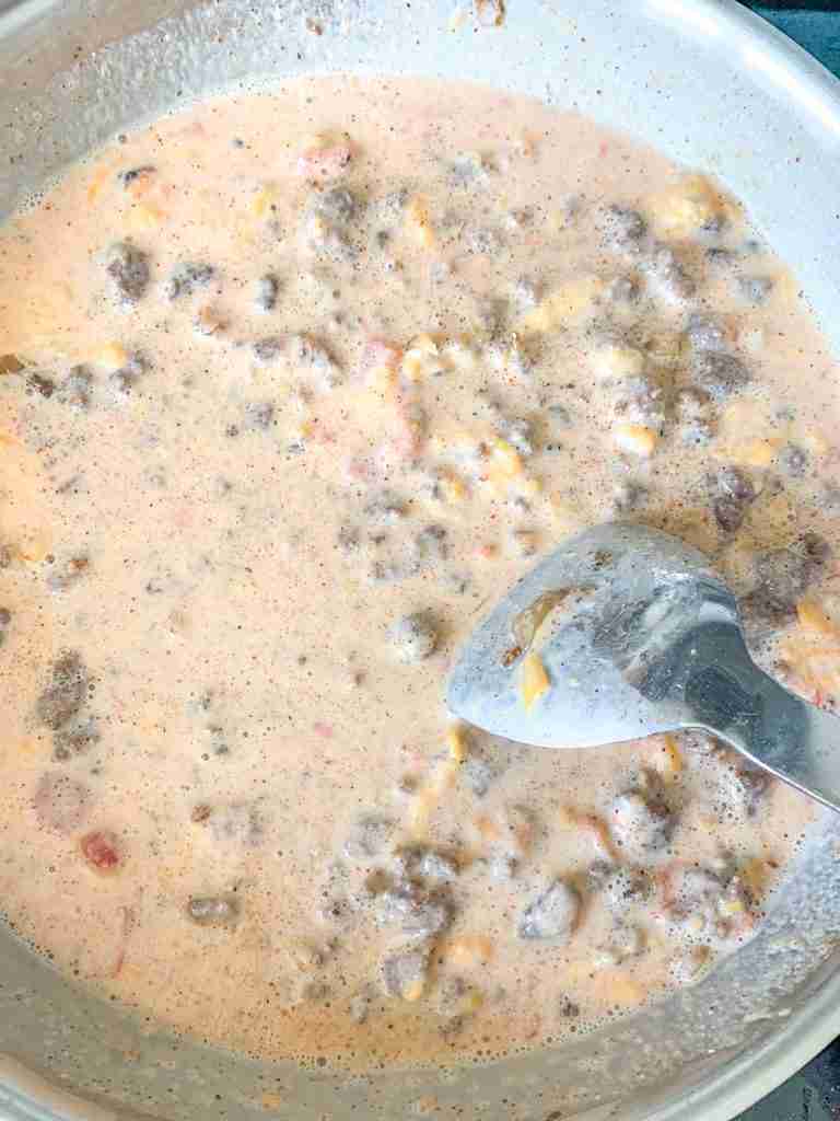 milk and tomatoes added to dip mix in the skillet