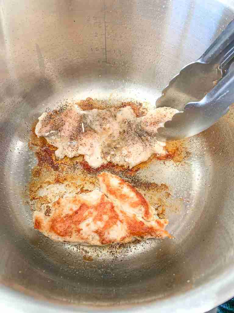 flipping chicken in a pot