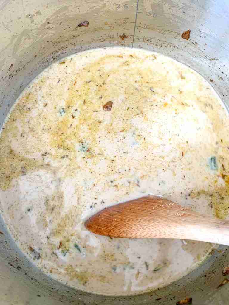 adding cream and spices into the pot