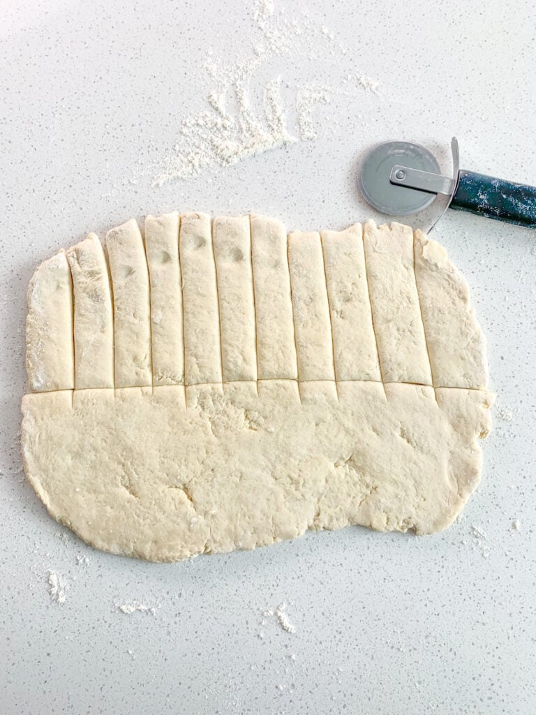 sourdough crescent roll dough sliced into strips