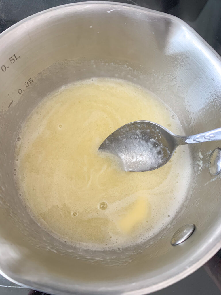 mixing honey butter topping for chicken minis in a pan