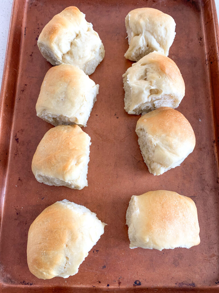 sourdough rolls on sheet pan ready to warm