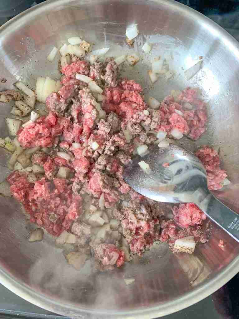 cooking ground beef and onions in a pan