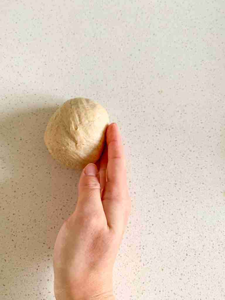 shaping dough into a bagel